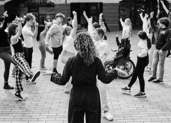 Black and white photo of diverse group of young people dancing